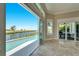 Living room with sliding doors opening to pool and water views at 1024 Sonata Ln, Apollo Beach, FL 33572