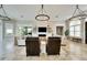 Open living area with comfortable seating, a fireplace, and large windows at 1024 Sonata Ln, Apollo Beach, FL 33572
