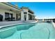 Inviting freeform pool with expansive patio and water access at 1024 Sonata Ln, Apollo Beach, FL 33572