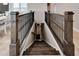 Elegant staircase with dark wood and wrought iron railings at 1024 Sonata Ln, Apollo Beach, FL 33572