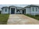 New gray house with driveway and landscaping at 10658 Rainsville St, Port Charlotte, FL 33981