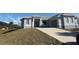 Gray house with landscaping and driveway at 10658 Rainsville St, Port Charlotte, FL 33981