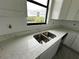 Double sink kitchen with white cabinets at 10658 Rainsville St, Port Charlotte, FL 33981