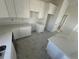 White kitchen with marble countertops at 10658 Rainsville St, Port Charlotte, FL 33981