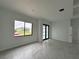 Spacious living area with marble floors and access to the backyard at 10658 Rainsville St, Port Charlotte, FL 33981