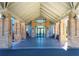 Brick clubhouse entrance with covered walkway and glass doors at 11440 Baronwood Ct, Hudson, FL 34667