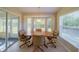 Casual dining area with wood table and chairs, near sliding glass doors at 11440 Baronwood Ct, Hudson, FL 34667