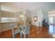 Open dining area with hardwood floors and view of the kitchen at 11440 Baronwood Ct, Hudson, FL 34667