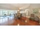 Bright dining room with glass-top table and view to kitchen and sunroom at 11440 Baronwood Ct, Hudson, FL 34667