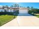 Single-story home with 2-car garage and manicured lawn at 11440 Baronwood Ct, Hudson, FL 34667