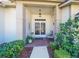 Inviting front porch with double doors, brick columns, and lush landscaping at 11440 Baronwood Ct, Hudson, FL 34667