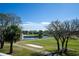 Golf course view with pond and fountain at 11440 Baronwood Ct, Hudson, FL 34667