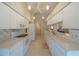 View of kitchen with white cabinets and appliances, open layout at 11440 Baronwood Ct, Hudson, FL 34667