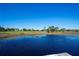Serene lakefront view with lush landscape and homes at 11440 Baronwood Ct, Hudson, FL 34667