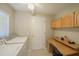 Laundry room with washer, dryer, and built-in desk at 11440 Baronwood Ct, Hudson, FL 34667