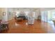 Open concept living room with hardwood floors and access to a sunroom at 11440 Baronwood Ct, Hudson, FL 34667