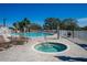 Community pool and spa with lounge chairs and brick patio at 11440 Baronwood Ct, Hudson, FL 34667