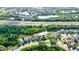 Aerial view of a residential neighborhood featuring houses, ponds, and roads at 12211 Oak Ramble Dr, Spring Hill, FL 34610