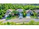 Aerial view of a residential neighborhood with houses and lush greenery at 12211 Oak Ramble Dr, Spring Hill, FL 34610