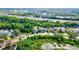 Aerial view of houses and a neighborhood with lush green landscape and ponds at 12211 Oak Ramble Dr, Spring Hill, FL 34610