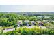 Aerial view of houses and a neighborhood with lush green landscape and ponds at 12211 Oak Ramble Dr, Spring Hill, FL 34610