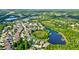 Wide aerial view of a residential neighborhood near a lake at 12211 Oak Ramble Dr, Spring Hill, FL 34610
