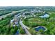 Aerial view of a residential community nestled near a lake and highway at 12211 Oak Ramble Dr, Spring Hill, FL 34610