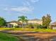 View of homes and a pond from a backyard at 12211 Oak Ramble Dr, Spring Hill, FL 34610