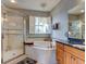 Large bathroom with a walk-in shower and a corner soaking tub at 12211 Oak Ramble Dr, Spring Hill, FL 34610