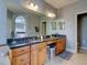 Double vanity bathroom with granite countertops and ample storage at 12211 Oak Ramble Dr, Spring Hill, FL 34610