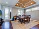 Dining area with hardwood floors and a coffered ceiling at 12211 Oak Ramble Dr, Spring Hill, FL 34610