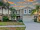 Two-story house with a light-colored facade and a welcoming entryway at 12211 Oak Ramble Dr, Spring Hill, FL 34610