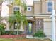 Two-story house with a teal door and stone accents at 12211 Oak Ramble Dr, Spring Hill, FL 34610