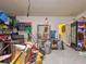 Over-cluttered garage with various items and storage solutions at 12211 Oak Ramble Dr, Spring Hill, FL 34610
