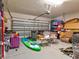 Over-cluttered garage with various items and storage solutions at 12211 Oak Ramble Dr, Spring Hill, FL 34610