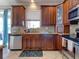 Bright kitchen with wood cabinets, granite counters, and stainless steel appliances at 12211 Oak Ramble Dr, Spring Hill, FL 34610