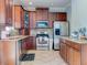 Updated kitchen with granite countertops, stainless steel appliances, and wood cabinets at 12211 Oak Ramble Dr, Spring Hill, FL 34610