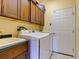 Laundry room with washer, dryer, cabinets, and utility sink at 12211 Oak Ramble Dr, Spring Hill, FL 34610