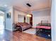 Bright living room features hardwood floors, a comfy couch, and stylish light fixture at 12211 Oak Ramble Dr, Spring Hill, FL 34610