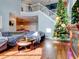 Relaxing living room with hardwood floors, sectional sofa, and a decorated Christmas tree at 12211 Oak Ramble Dr, Spring Hill, FL 34610