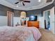 Main bedroom with a king-size bed and an ensuite bathroom at 12211 Oak Ramble Dr, Spring Hill, FL 34610