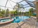 Enclosed pool and spa with a covered patio at 12211 Oak Ramble Dr, Spring Hill, FL 34610