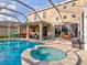 Inviting pool area with spa and screened enclosure at 12211 Oak Ramble Dr, Spring Hill, FL 34610
