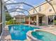 Inviting pool area with spa and screened enclosure at 12211 Oak Ramble Dr, Spring Hill, FL 34610