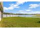 Spacious backyard with a white fence overlooking a lake at 12931 Twin Bridges Dr, Riverview, FL 33579