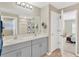 Double vanity bathroom with gray cabinets and a shower/tub combo at 12931 Twin Bridges Dr, Riverview, FL 33579