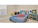 Bright bedroom with a twin-size bed and built-in shelving at 12931 Twin Bridges Dr, Riverview, FL 33579