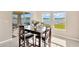 Dining area with a wooden table and chairs, overlooking a lake at 12931 Twin Bridges Dr, Riverview, FL 33579