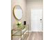 Bright entryway with a glass-top console table and a round gold mirror at 12931 Twin Bridges Dr, Riverview, FL 33579