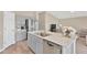 Modern kitchen with gray cabinets, stainless steel appliances, and an island at 12931 Twin Bridges Dr, Riverview, FL 33579
